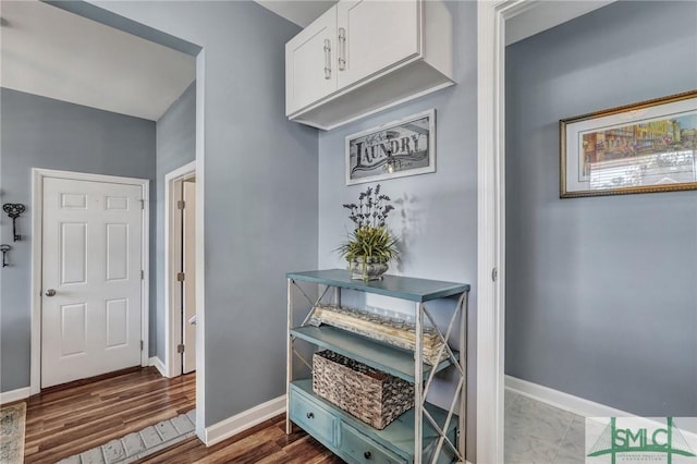 interior space featuring baseboards and wood finished floors