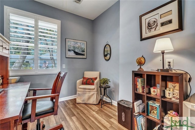 office space featuring visible vents, baseboards, and wood finished floors