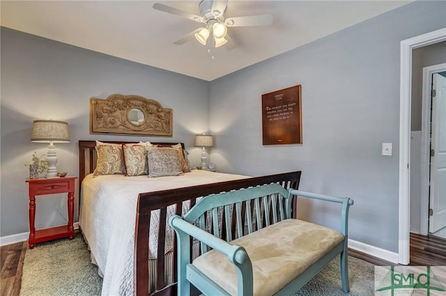 bedroom with a ceiling fan, baseboards, and wood finished floors