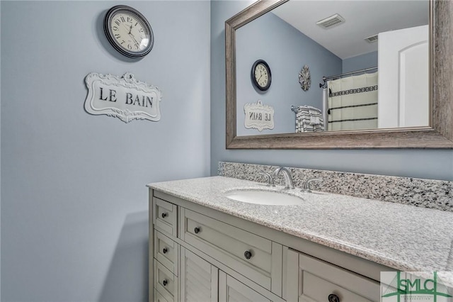 bathroom featuring vanity and visible vents