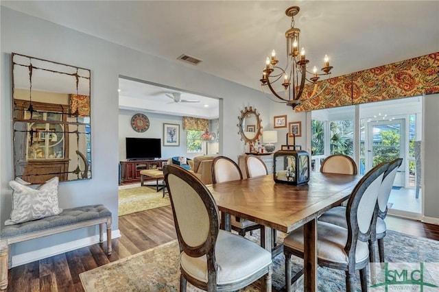 dining room with visible vents, ceiling fan, baseboards, and wood finished floors