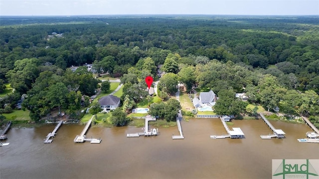 birds eye view of property featuring a water view and a forest view