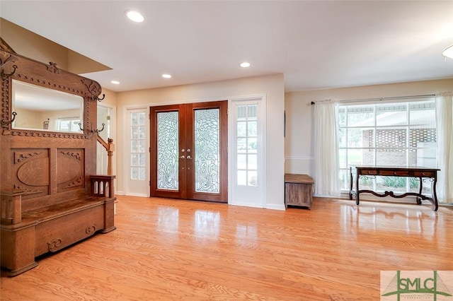 foyer featuring french doors, recessed lighting, wood finished floors, baseboards, and stairs