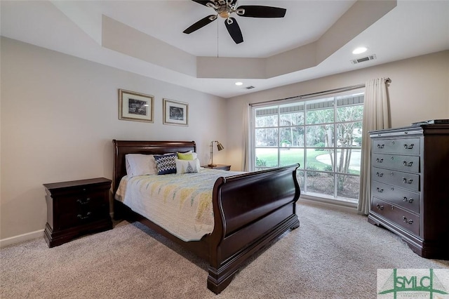 bedroom featuring visible vents, a raised ceiling, baseboards, carpet, and access to outside