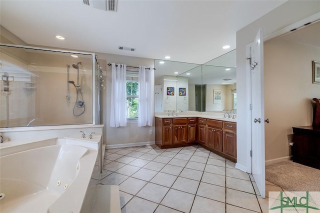 bathroom with visible vents, tile patterned floors, a jetted tub, a shower stall, and a sink