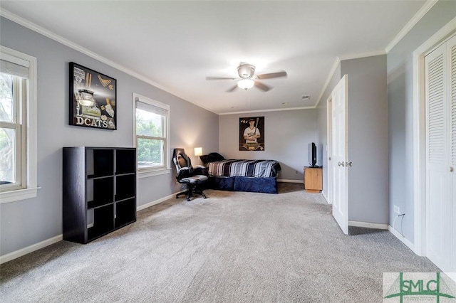 bedroom featuring crown molding, carpet floors, a ceiling fan, and baseboards