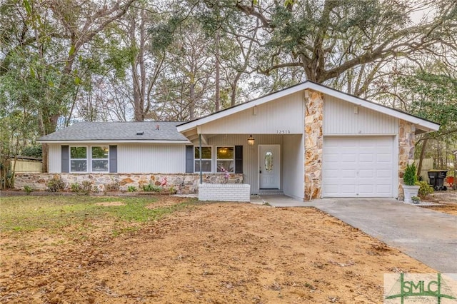 ranch-style house with an attached garage, stone siding, and driveway