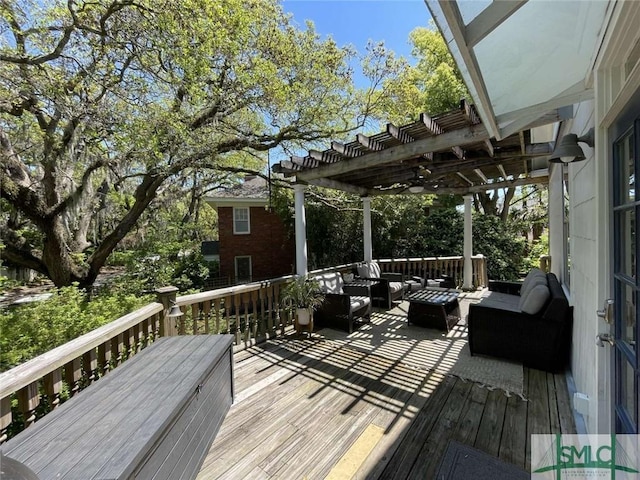 wooden deck featuring an outdoor living space and a pergola