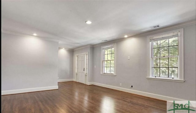 unfurnished room featuring recessed lighting, wood finished floors, visible vents, baseboards, and crown molding