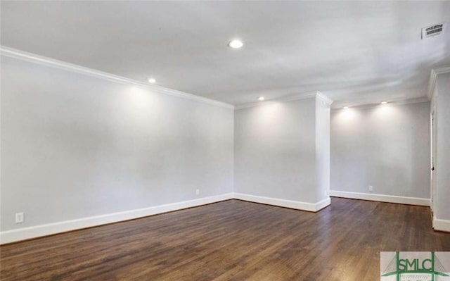 spare room featuring recessed lighting, dark wood-type flooring, visible vents, baseboards, and ornamental molding