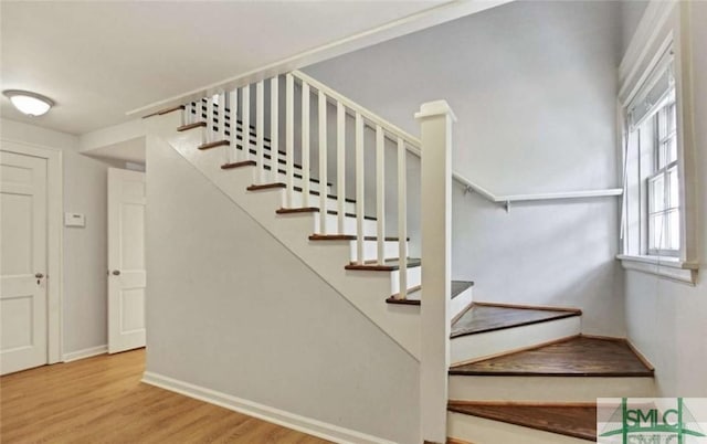 stairs featuring baseboards and wood finished floors