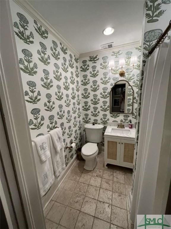 bathroom with ornamental molding, visible vents, toilet, and wallpapered walls