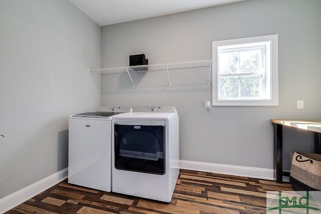 laundry area with laundry area, wood finished floors, washing machine and clothes dryer, and baseboards