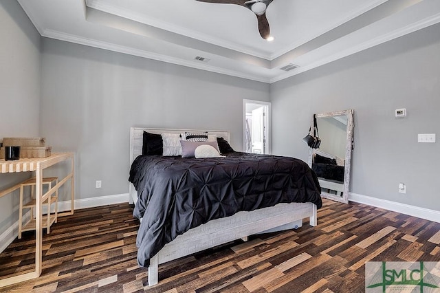 bedroom featuring a tray ceiling, visible vents, and baseboards