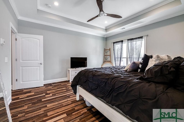 bedroom featuring baseboards, ornamental molding, dark wood-type flooring, a tray ceiling, and recessed lighting