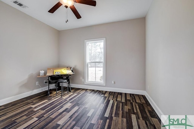 unfurnished office featuring a ceiling fan, visible vents, baseboards, and wood finished floors