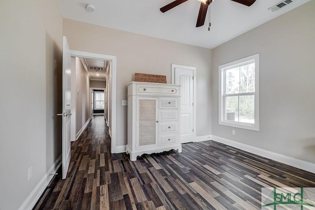 unfurnished bedroom featuring attic access, visible vents, baseboards, and multiple windows