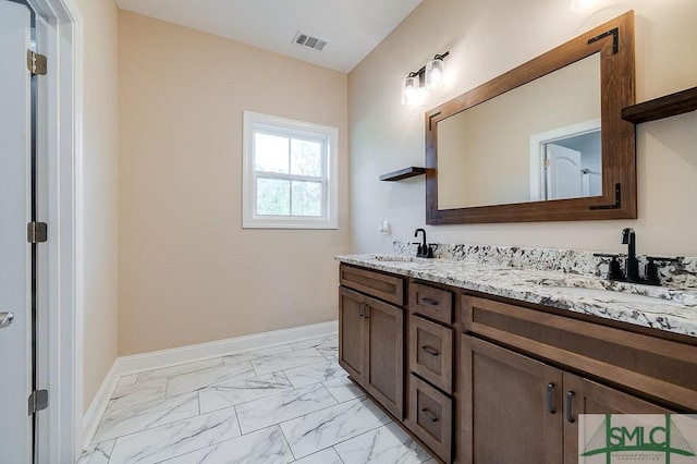 full bathroom featuring marble finish floor, baseboards, visible vents, and a sink