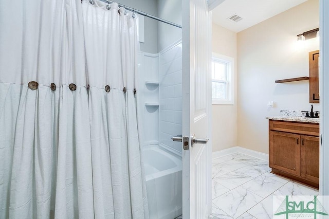 bathroom with marble finish floor, visible vents, shower / tub combo, vanity, and baseboards