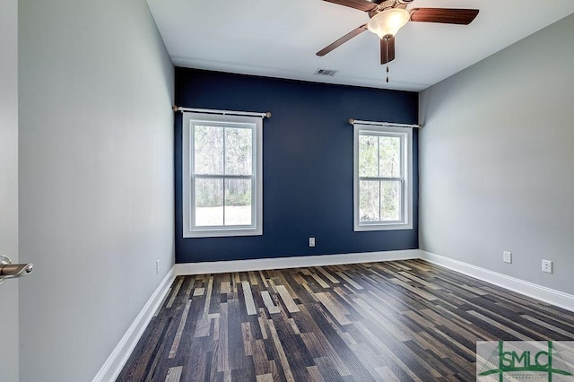 unfurnished room featuring a ceiling fan, visible vents, baseboards, and wood finished floors