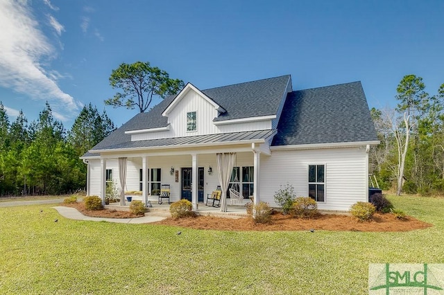 modern farmhouse with a standing seam roof, roof with shingles, metal roof, and a front yard