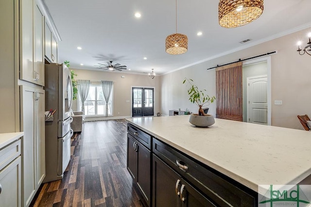 kitchen featuring a barn door, ornamental molding, open floor plan, dark wood-type flooring, and stainless steel refrigerator with ice dispenser