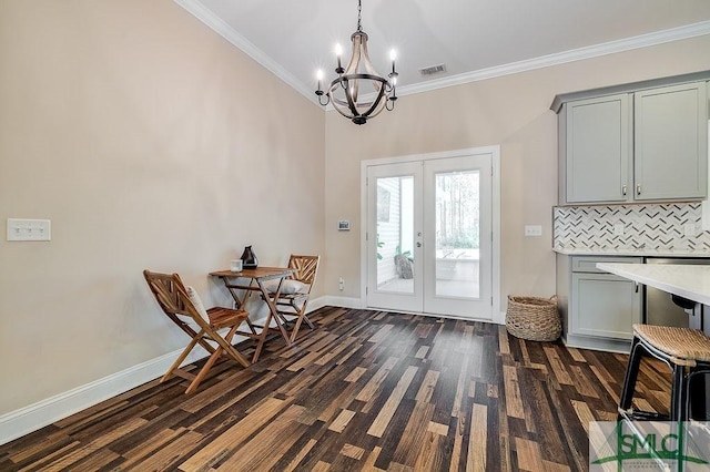 doorway featuring baseboards, visible vents, french doors, and ornamental molding