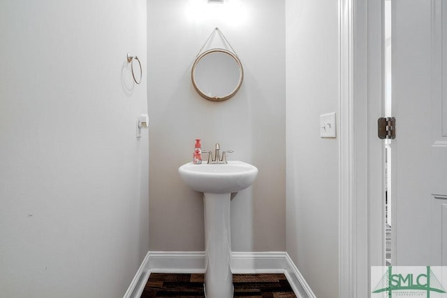 bathroom featuring wood finished floors and baseboards