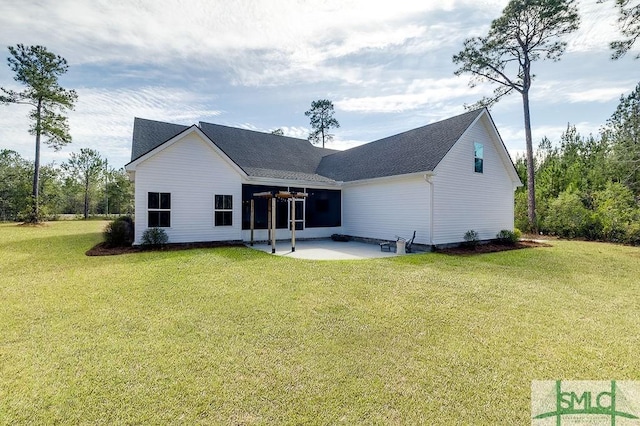 back of house with a patio area and a yard