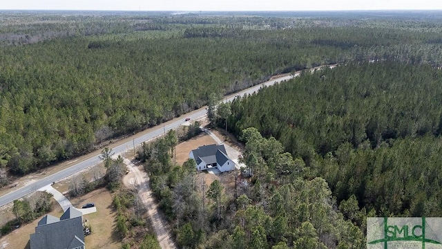 birds eye view of property with a wooded view