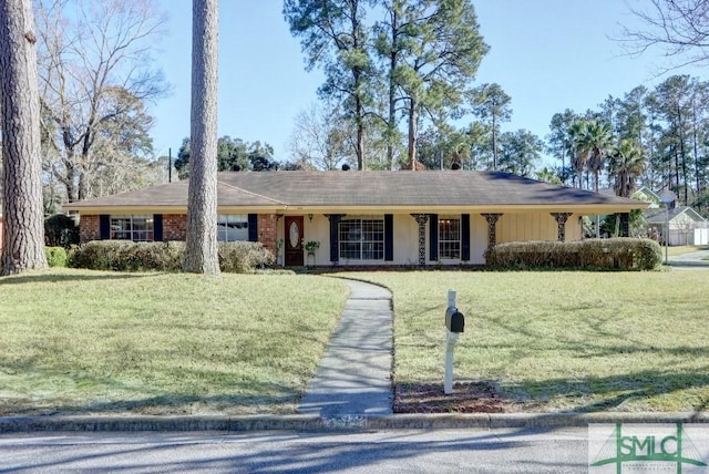 single story home with a garage, brick siding, and a front lawn