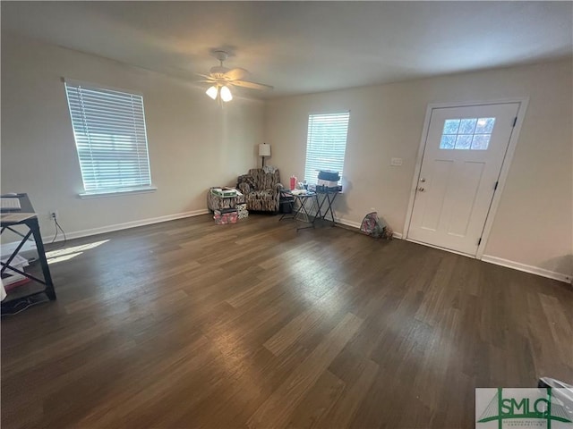 foyer featuring dark wood-type flooring, a ceiling fan, and baseboards