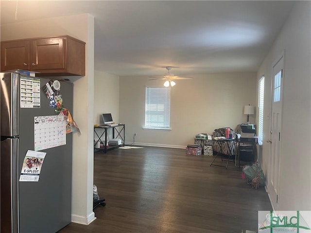 kitchen with freestanding refrigerator, dark wood-style flooring, a healthy amount of sunlight, and baseboards