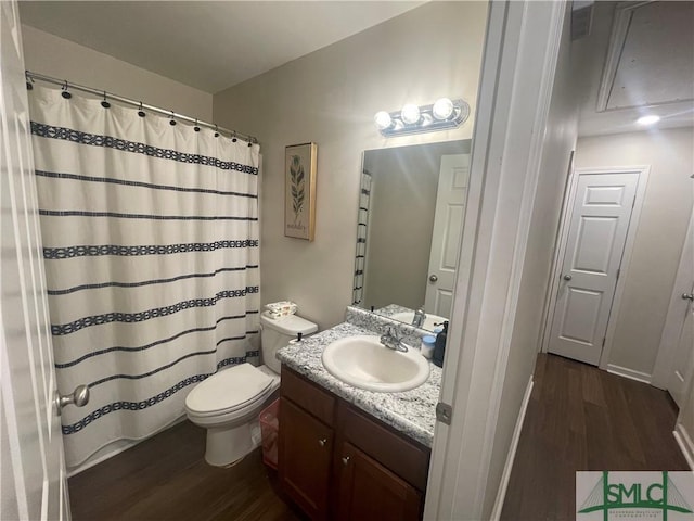 bathroom with a shower with curtain, vanity, toilet, and wood finished floors