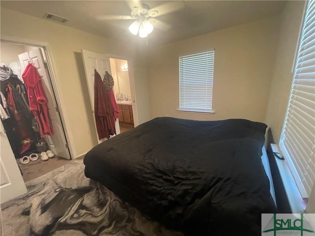 bedroom featuring a ceiling fan and visible vents