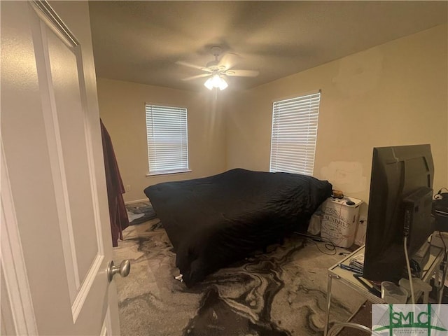 carpeted bedroom featuring a ceiling fan and baseboards