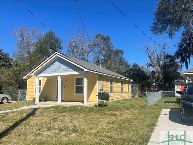 view of home's exterior featuring fence and a lawn