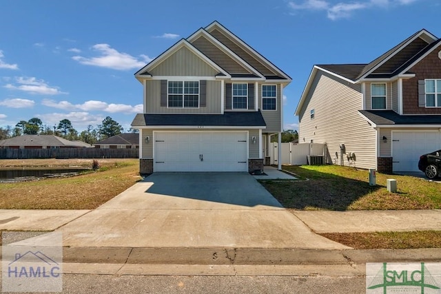 craftsman-style house with an attached garage, cooling unit, fence, driveway, and board and batten siding