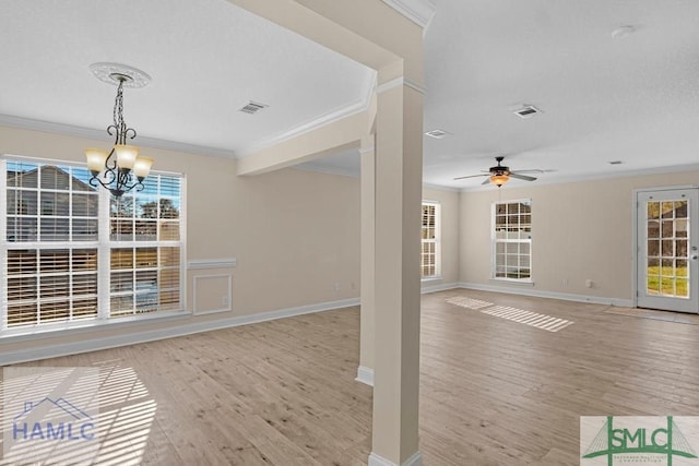 interior space featuring light wood finished floors, ornamental molding, and visible vents