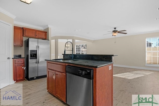 kitchen with crown molding, stainless steel appliances, a sink, light wood-type flooring, and ornate columns