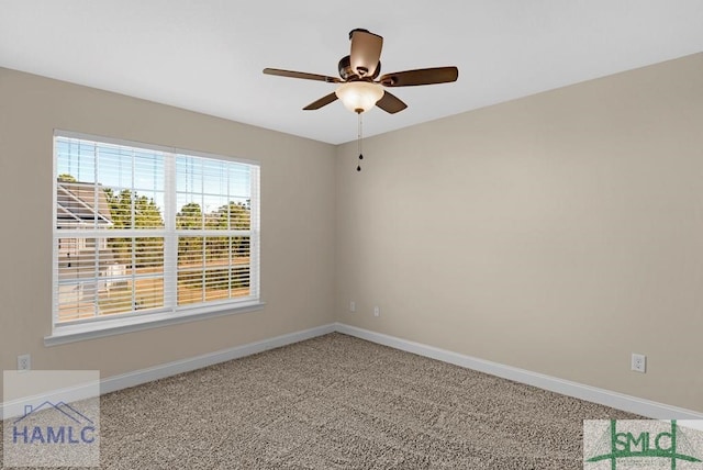 spare room with carpet, ceiling fan, and baseboards