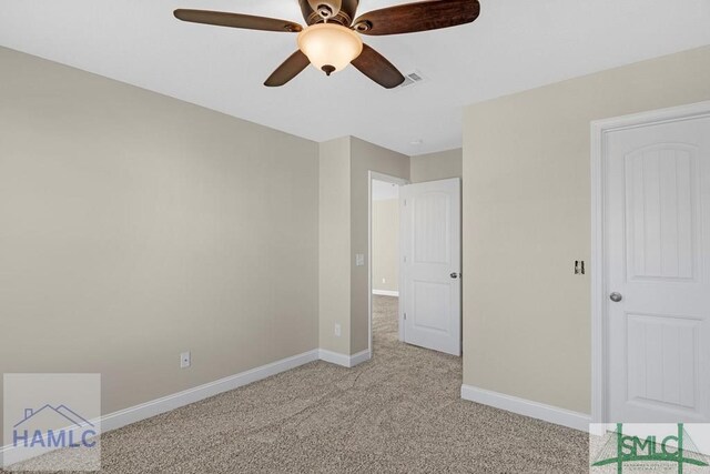 unfurnished bedroom with visible vents, baseboards, a ceiling fan, and light colored carpet