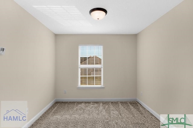 unfurnished room with light colored carpet and baseboards