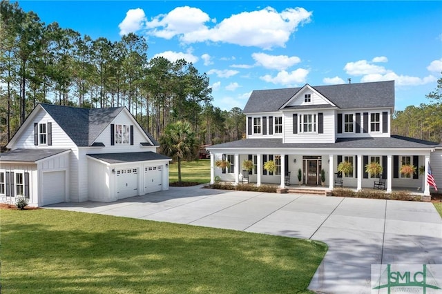 view of front of home with a porch, an attached garage, driveway, and a front lawn