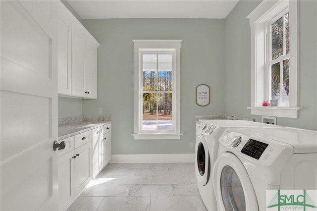 washroom with marble finish floor, cabinet space, independent washer and dryer, and baseboards