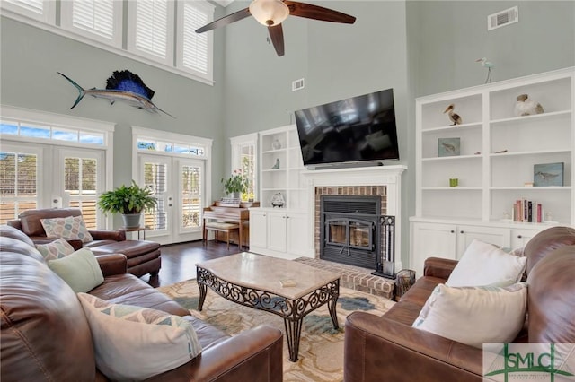 living area featuring french doors, wood finished floors, visible vents, and a healthy amount of sunlight