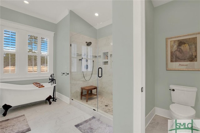 bathroom featuring a freestanding tub, toilet, baseboards, marble finish floor, and a shower stall