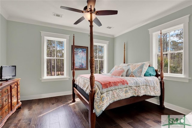 bedroom with crown molding, dark wood-type flooring, visible vents, and baseboards