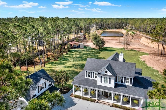 bird's eye view with a water view and a wooded view