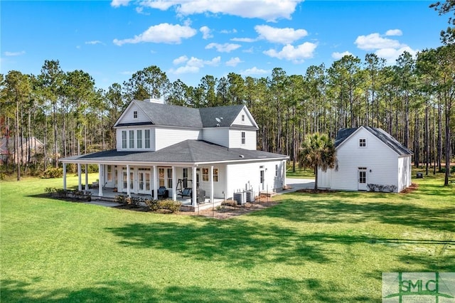 rear view of house with covered porch, central AC, and a lawn